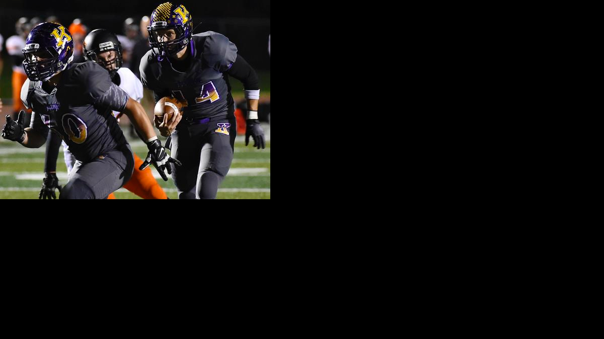 
Kearney quarterback Johnny Weidmaier (with ball) follows his blocker in a game against Platte County earlier this season.
