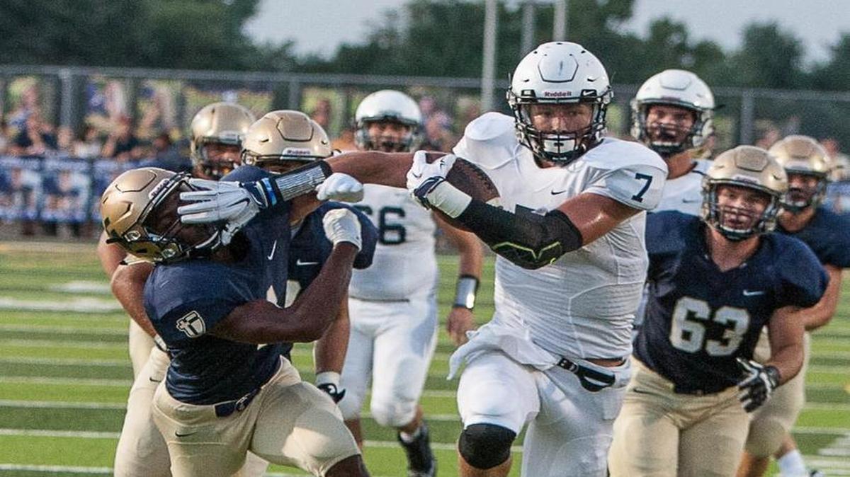 
Mill Valley receiver Luke Kroll used a stiff arm on Aquinas’ Duron Lowe on his way to a touchdown against Aquinas on Friday night.
