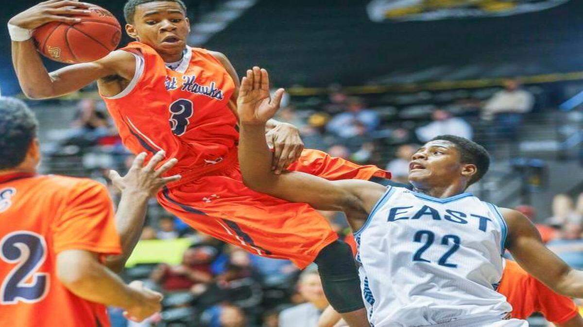 
Olathe East’s Javion Blake (with ball) was fouled by Wichita East’s Xavier Kelly on a rebound in the second quarter of their Kansas 6A state semifinal game on Friday in Wichita. Olathe East lost to Wichita East, 59-52.
