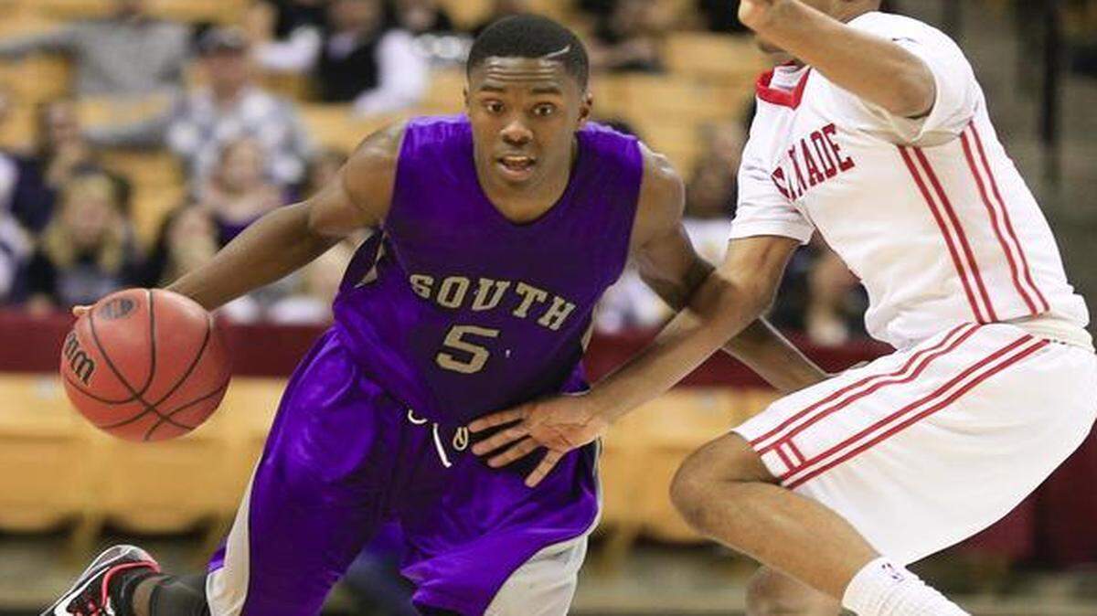 
James Byrd (left) of Park Hill South controlled the basketball despite the defense of Chaminade’s Reggie Crawford during their Missouri Class 5 state semifinal game last Friday at Mizzou Arena. Park Hill South defeated Chaminade 53-50.
