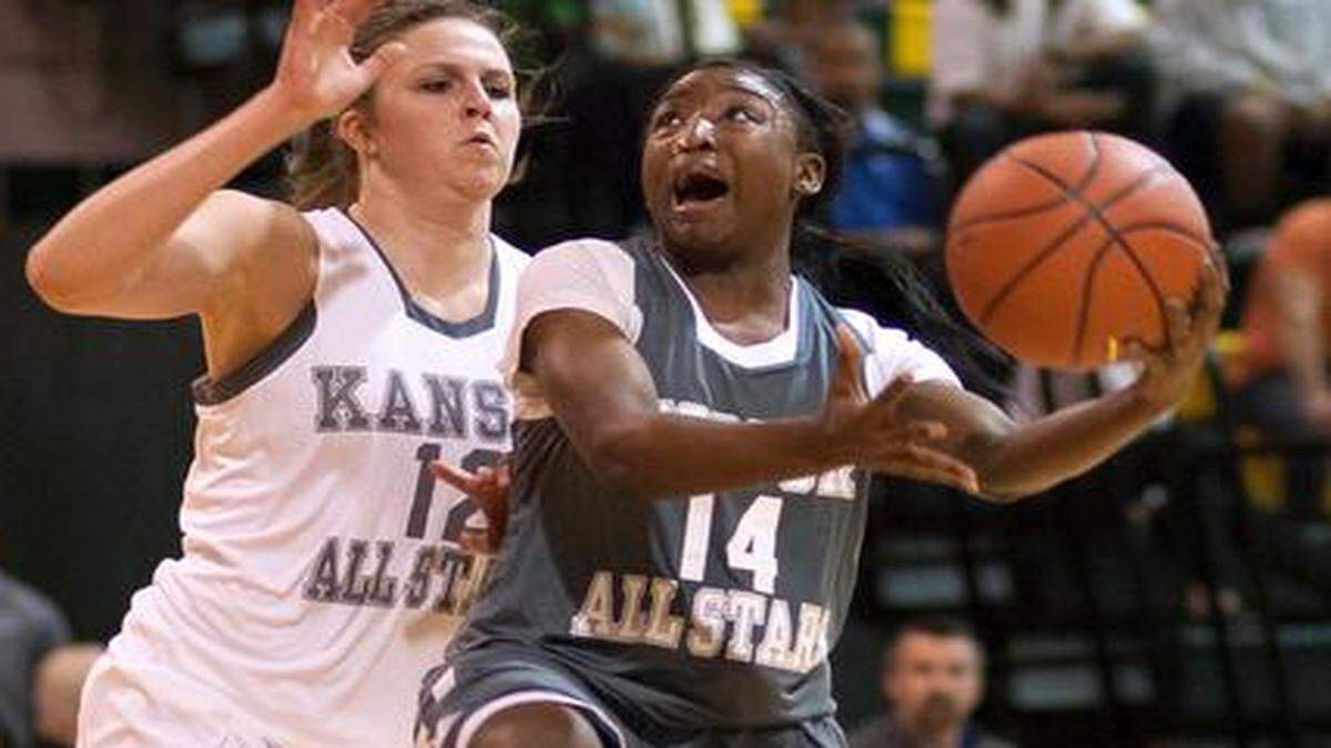 
Kyessence Collins of Raytown tried to get to the basket against Tatum Graves of Shawnee Mission Northwest in the girls all-star game on Friday night.
