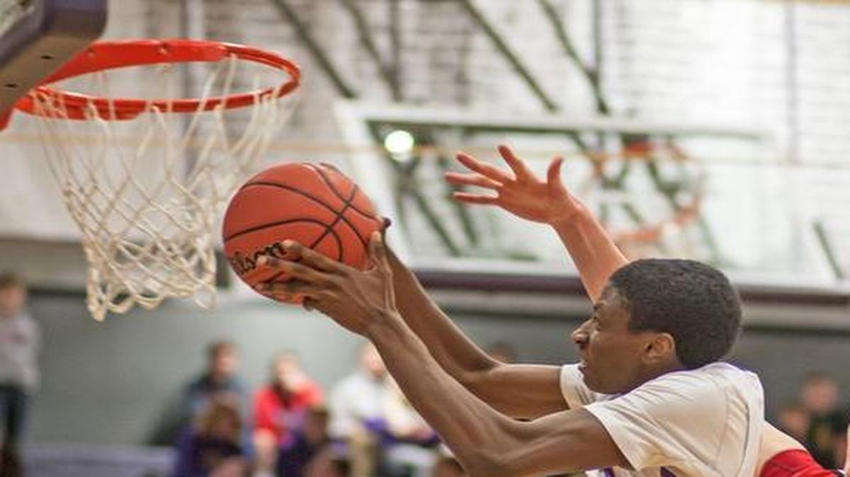 Blue Springs’ Justin Hall took the ball to the basket Friday in front of Park Hill’s Tanner Zeil.