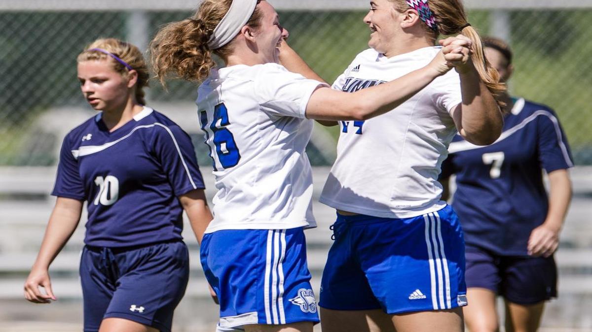 Summit Christian Academy’s Sky Masters (right) celebrated with teammate Shelby Brown after Masters’ first-half goal on Thursday in the state third-place match.