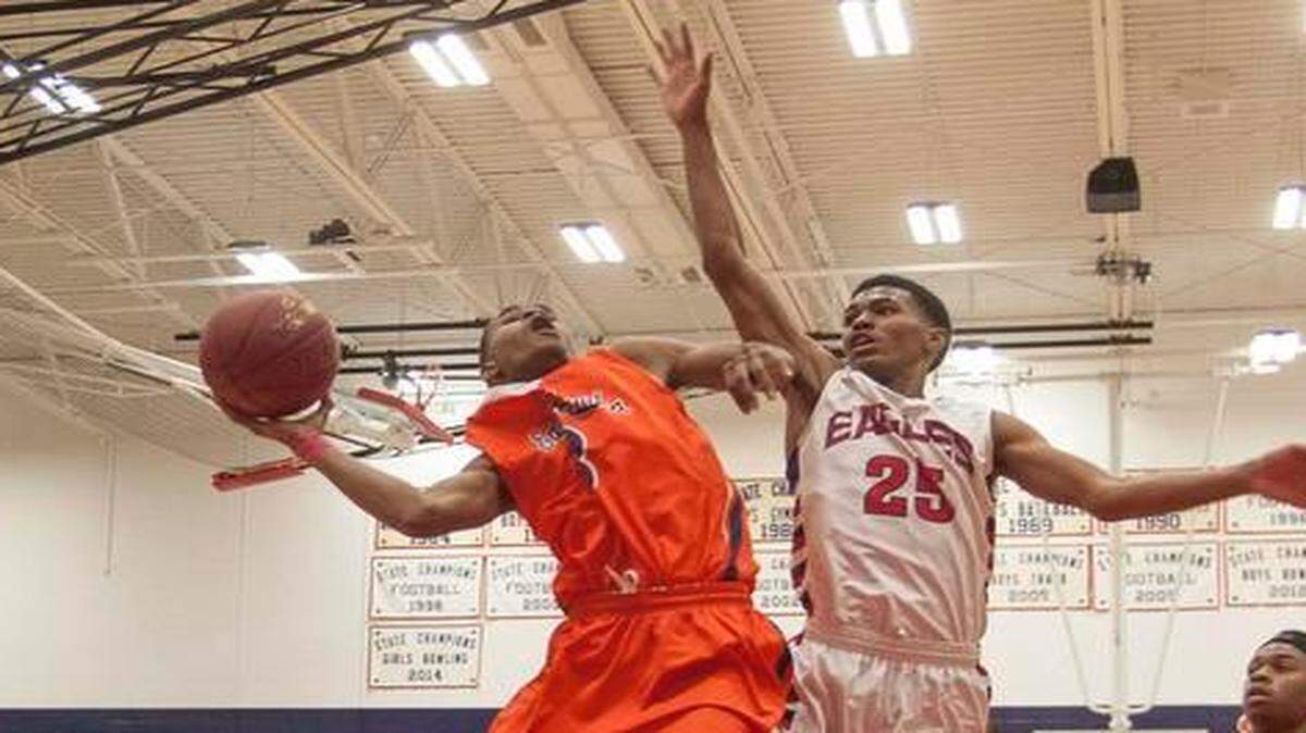 
Olathe East’s Javion Blake (left) got most of his points at the basket on Friday against Olathe North.


