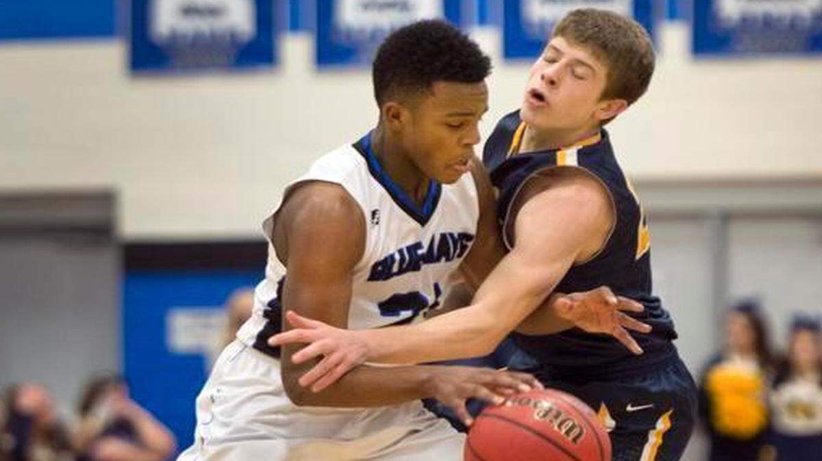 
The Raytown High School boys defeated Liberty North on Friday evening, Feb. 6, 2015, at Raytown High. JD Braden (right) of Liberty North tried to slap the ball away from Will Nelson of Raytown in the first quarter.
