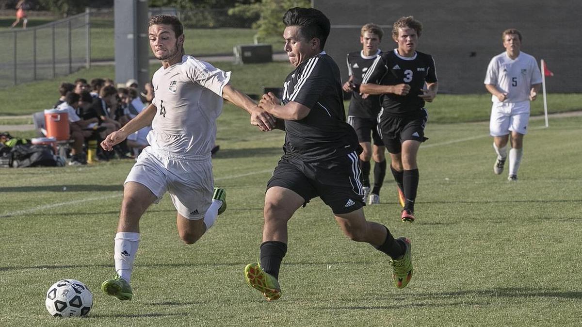 Grayson Rapp (left) of Shawnee Mission East, seen here in a KA-MO Classic boys soccer tournament match last week, scored one of the three Lancers’ goals on Saturday against Lee’s Summit North, which gave SM East the championship of the elite tournament.