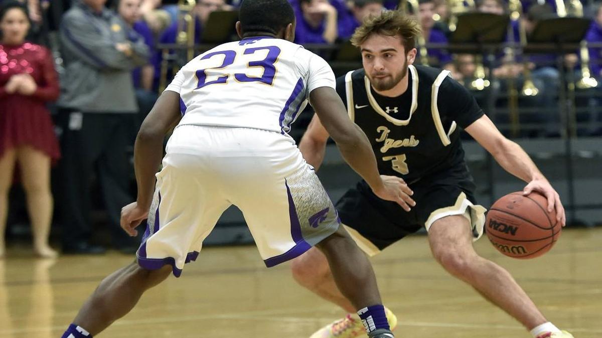 Lee's Summit senior Blake Spellman dribbles around Blue Springs junior Tyree King during Tuesday's boys basketball game in Blue Springs.