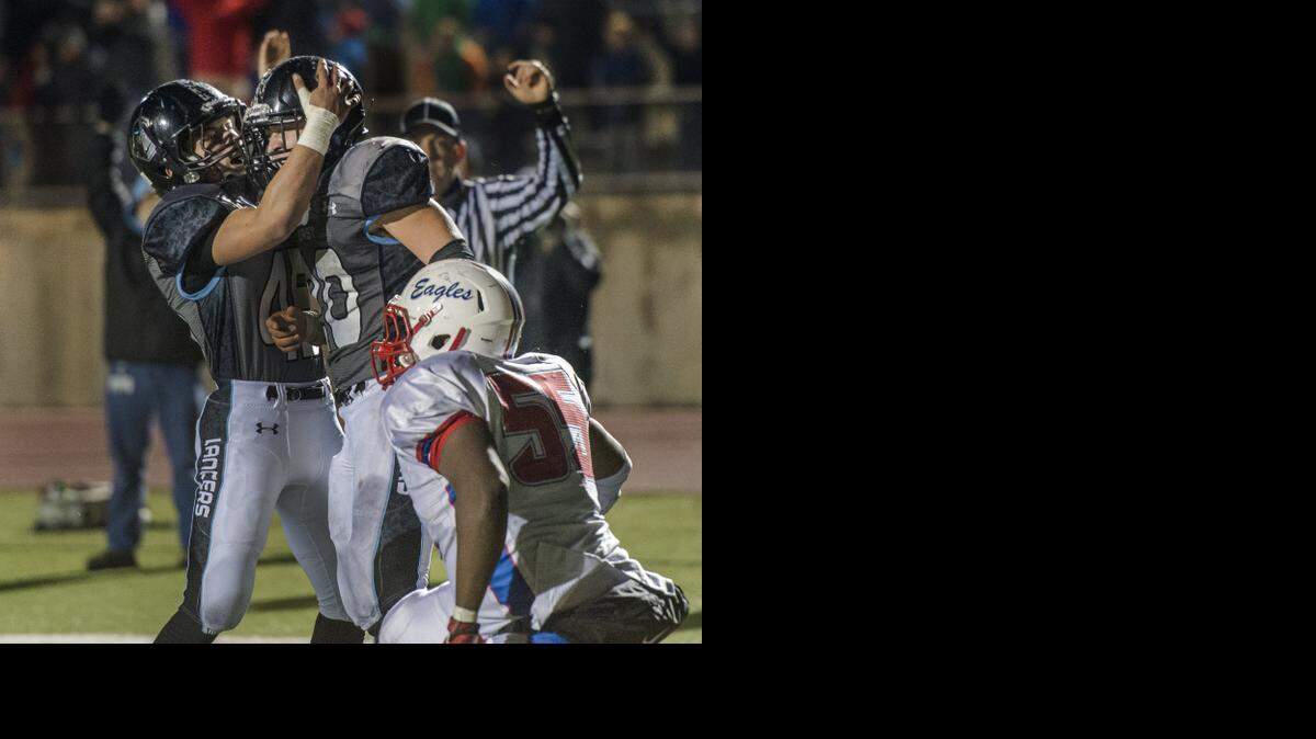 
Shawnee Mission East’s Mike Bamford (No. 45) celebrated teammate Wyatt Edmisten’s touchdown in front of Marcel Williams of Olathe North during their Kansas Class 6A substate playoff game on Friday night. SM East won the game, 36-35, in double overtime.
