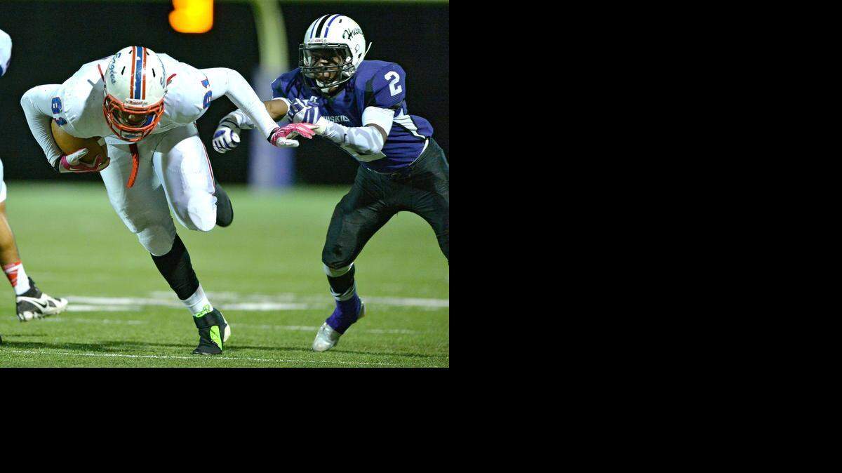 
Olathe North's Josh Moore (with ball) runs past Blue Valley Northwest's Jaqwan Stone for a second-quarter touchdown during their game game last season on November 8. Moore and teammate Marcel Spears have made commitments to play at Division I colleges.
