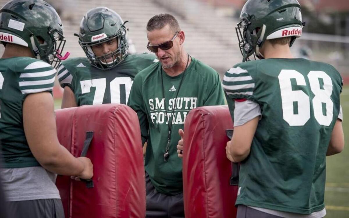 Shawnee Mission South coach Brett Oberzan explained some technique during an August football practice in Overland Park.