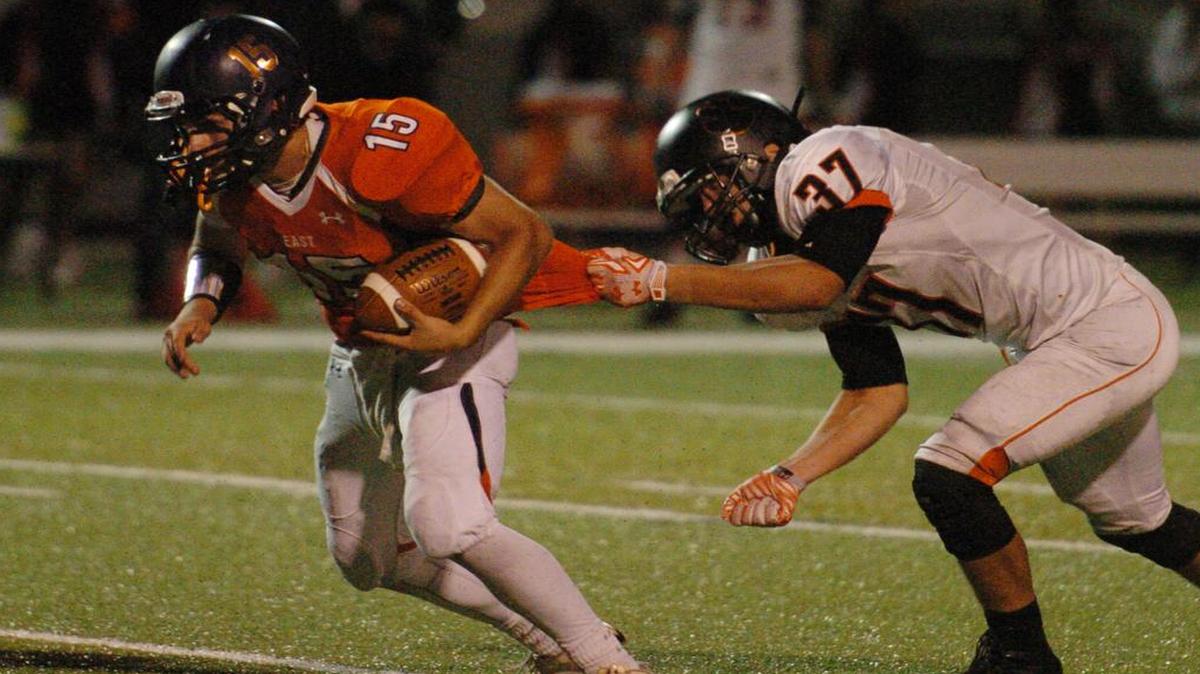 
Olathe East quarterback Daulton East was pulled back by his jersey by Shawnee Mission Northwest’s Tyler Holland during their game last Thursday night at the College Boulevard Activity Center.
