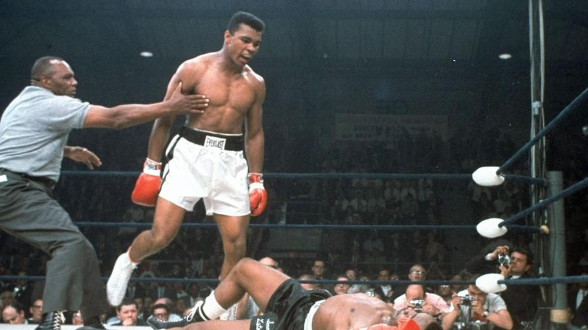 In this May 25, 1965, file photo, heavyweight champion Muhammad Ali is held back by referee Joe Walcott, left, after Ali knocked out challenger Sonny Liston in the first round of their title fight in Lewiston, Maine. Ali, the magnificent heavyweight champion whose fast fists and irrepressible personality transcended sports and captivated the world, has died according to a statement released by his family Friday, June 3, 2016. He was 74.