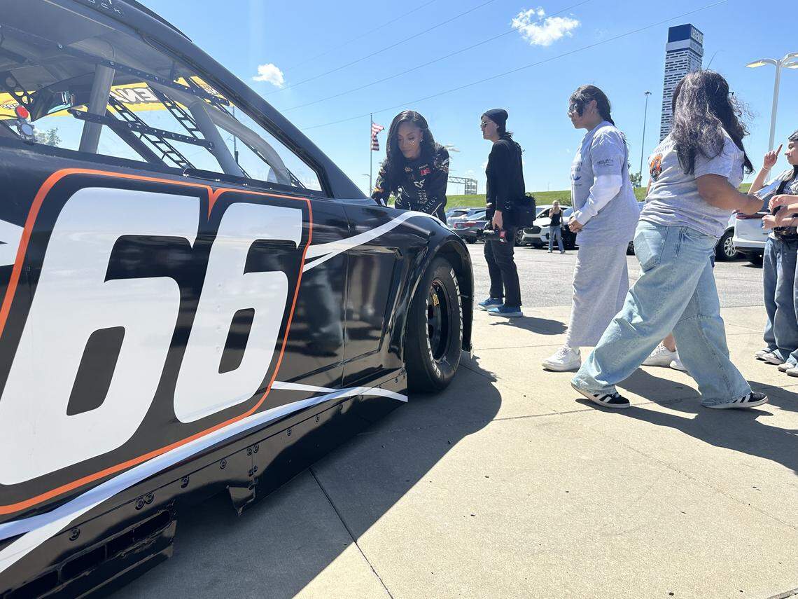 Stock car driver Dystany Spurlock signs autographs for Gloria Willis Middle School students at Victory Ford in Kansas City, Kansas.