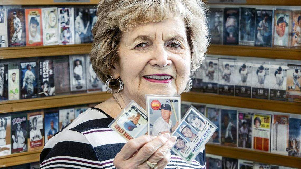 
Marilyn Williams, owner of Show-Me Sports Cards, displays three of her favorite baseball cards picturing (from left) Nolan Ryan, Mickey Mantle and Cal Ripken in her Blue Springs store. Only a scattering of sports card shops remain open in the Kansas City area, reflecting a decline in card popularity brought on by the digital age, increasing costs and the performance-enhancing drug era.
