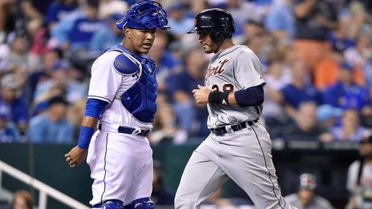 
The Tigers' J.D. Martinez (28) scores past Royals catcher Salvador Perez on a single by Eugenio Suarez in the fifth inning during Friday's baseball game at Kauffman Stadium.
