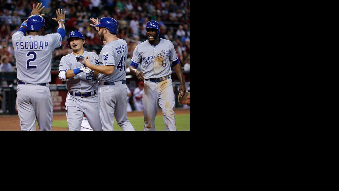 
Teammates Danny Duffy (41), Lorenzo Cain (6) and Alcides Escobar (2) greeted Nori Aoki at home plate after he drove them all home with a grand slam home run in the fifth inning against the Arizona Diamondbacks on Tuesday night in Phoenix.

