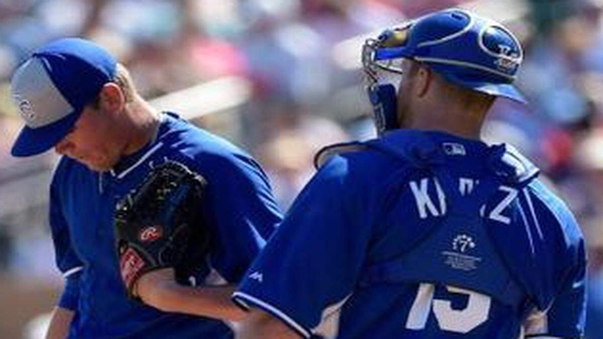 
Royals pitcher Aaron Brooks (62), a reliever who was tapped for a spot start on Sunday, conferred with catcher Erik Kratz (19) after giving up a hit to the Colorado Rockies in Cactus League action Sunday in Scottsdale, Ariz. The Royals lost the game 6-2

