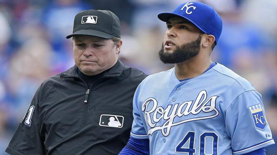 
Royals relief pitcher Kelvin Herrera was escorted from the field by umpire Marvin Hudson after Herrera was ejected for pitching inside to Oakland’s Brett Lawrie in the eighth inning Sunday at Kauffman Stadium.
