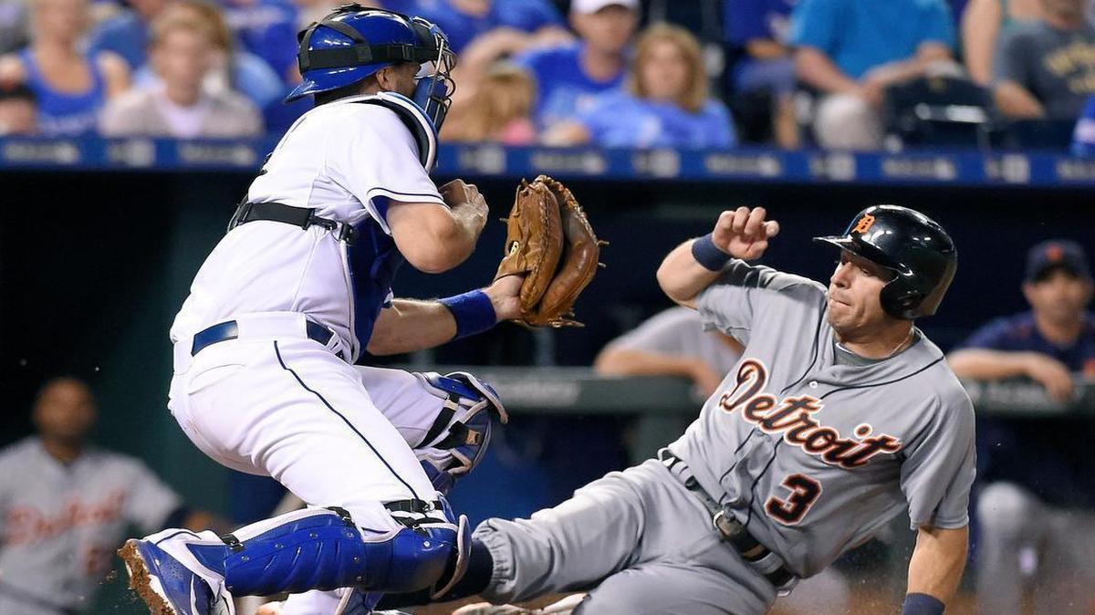 
The Tigers’ Ian Kinsler (3) scored under the tag of Royals catcher Drew Butera (9) on a grounder by Tyler Collins in the eighth inning Wednesday night at Kauffman Stadium.
