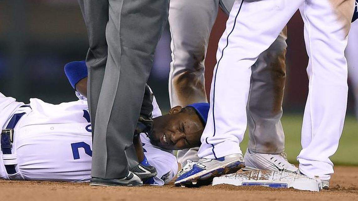 
Oakland Athletics’ Brett Lawrie (15) exchanged words with Kansas City Royals second baseman Omar Infante (14) after shortstop Alcides Escobar (2) was injured and on the ground in pain during the seventh inning Friday at Kauffman Stadium.
