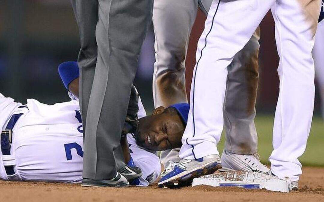 
Oakland Athletics’ Brett Lawrie (15) exchanged words with Kansas City Royals second baseman Omar Infante (14) after shortstop Alcides Escobar (2) was injured and on the ground in pain during the seventh inning Friday at Kauffman Stadium.
