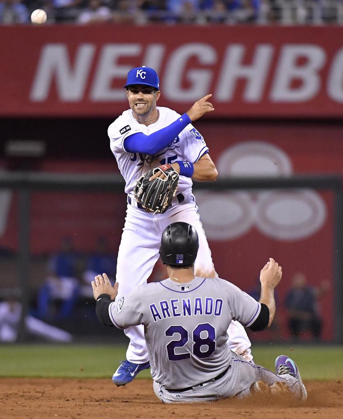 Kansas City Royals second baseman Whit Merrifield completes a double play during a game against Colorado. “He’s one of those guys,” said teammate Alex Gordon, “when you add up all the categories — base running, defense, offense, then you start to appreciate the full picture.”