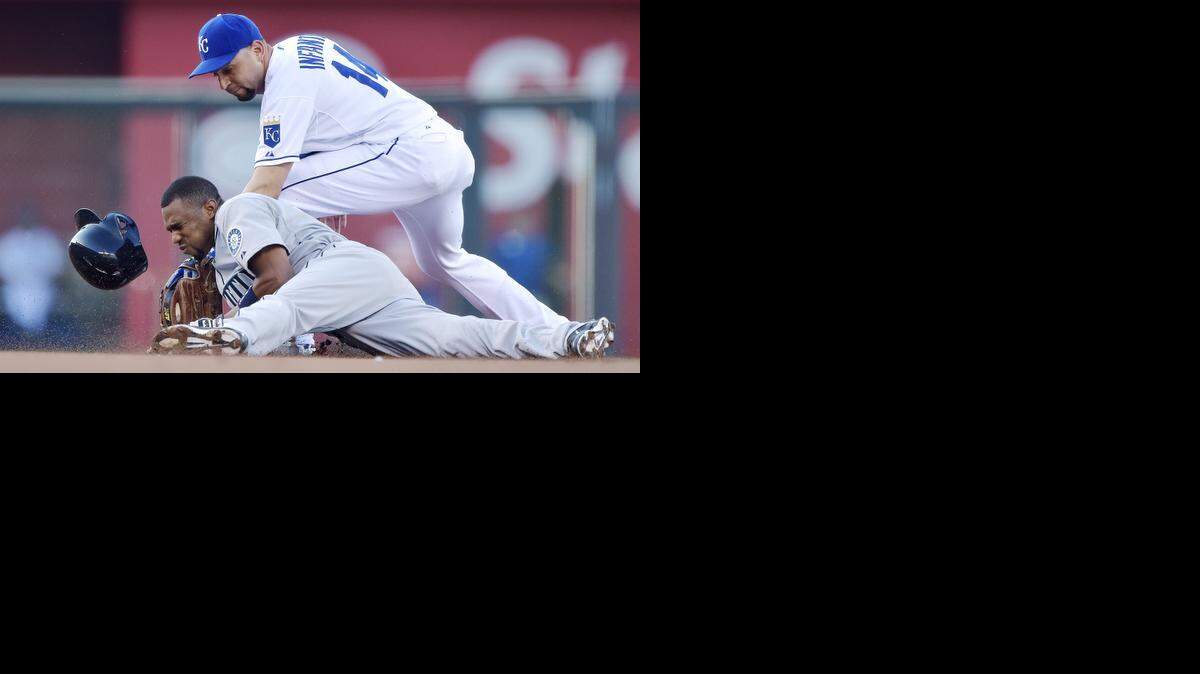 The Mariners' Endy Chavez reaches second before the tag from Royals second baseman Omar Infante on a double during Friday's baseball game at Kauffman Stadium.