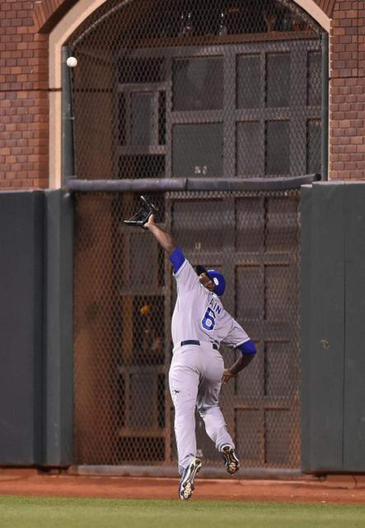 Kansas City Royals center fielder Lorenzo Cain runs down to catch the fly ball hit by San Francisco Giants Hunter Pence during the fifth inning in game five of the World Series on Sunday, October 26, 2014 at AT&T Park in San Francisco, Calif.