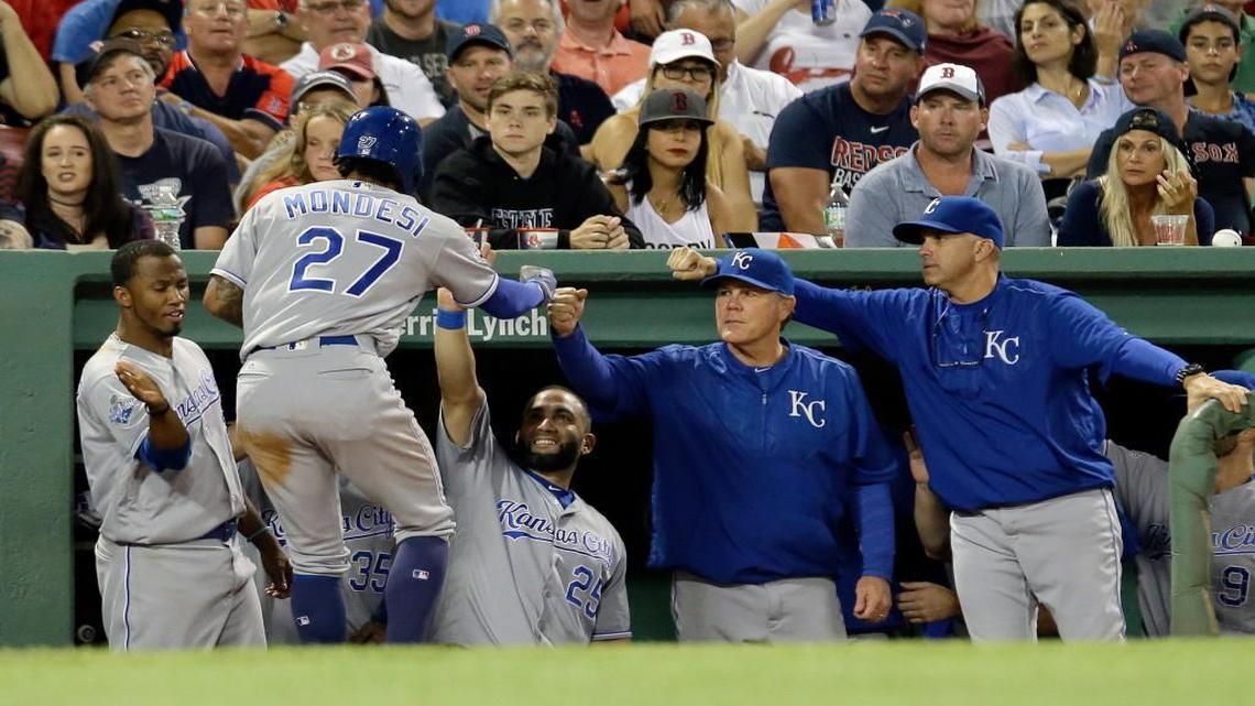 Royals coaches and players welcomed Raul Mondesi (27) back to the dugout after scoring in Kansas City’s eight-run sixth inning Sunday night against the Red Sox in Boston.