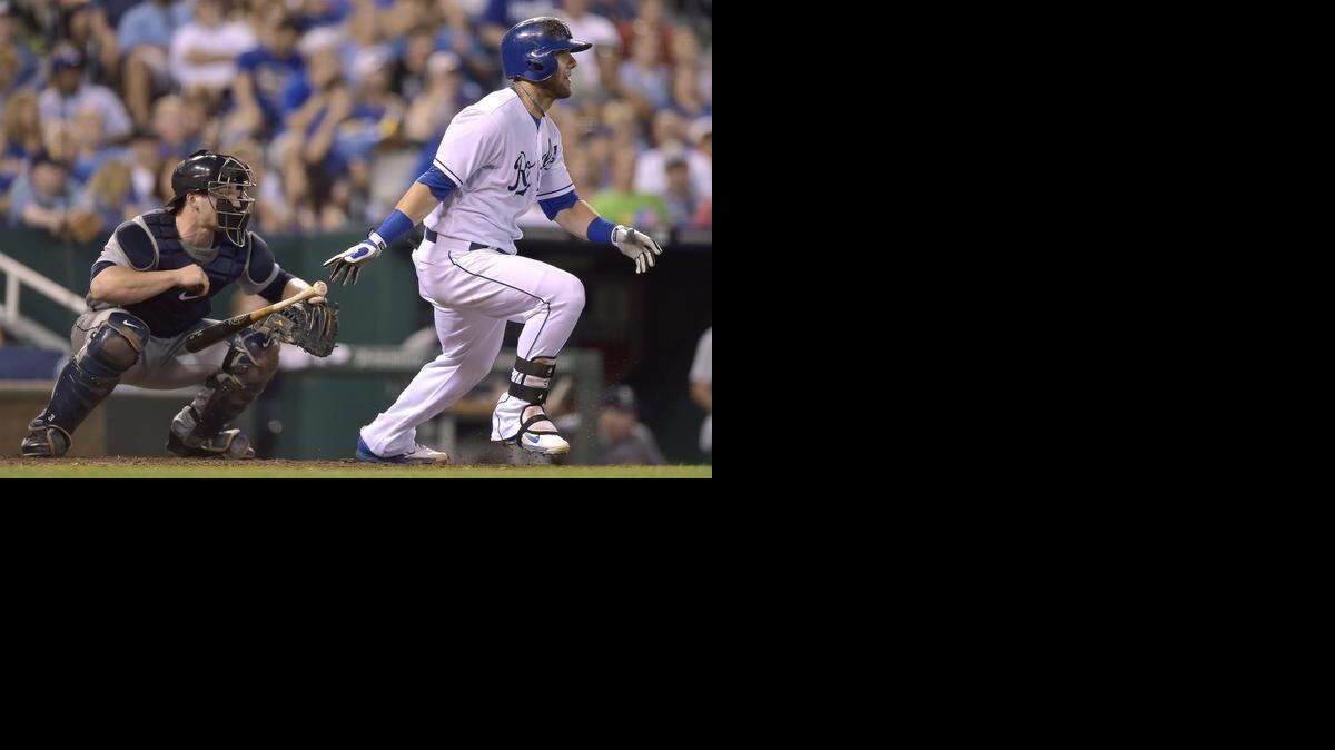 
Kansas City Royals' Alex Gordon (4) follows through on a single in the eighth inning in front of Seattle Mariners catcher Mike Zunino (3) during Friday's baseball game at Kauffman Stadium on June 20, 2014 in Kansas City, Mo.

