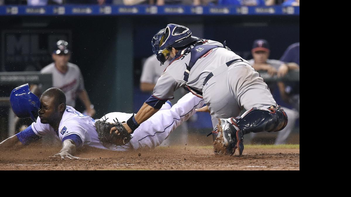 
The Royals' Royals' Lorenzo Cain (6) scores ahead of the tag from Twins catcher Kurt Suzuki (8) in the 10th inning on a fielders choice hit into by Jarrod Dyson for a 3-2 win by the Royals during Friday's baseball game at Kauffman Stadium.
