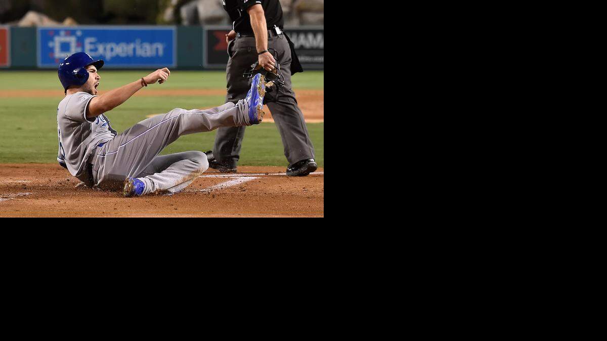 
Royals first baseman Eric Hosmer slid in safely for the first run in the second inning and hit a two-run homer in the 11th for the go-ahead runs.


