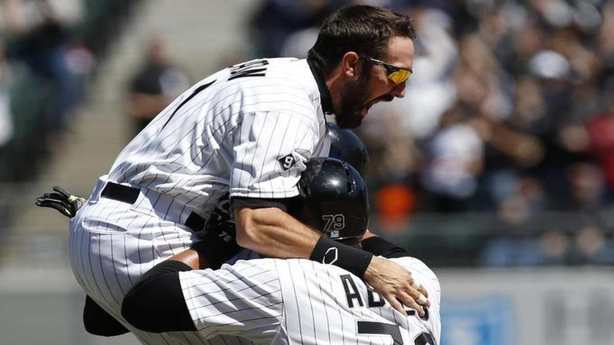 
Chicago White Sox center fielder Adam Eaton (1) jumped on teammates Avisail Garcia (26) and Jose Abreu (79) after Garcia hit the game-winning single in the ninth inning Sunday, beating the Royals 3-2 in a game that was suspended Friday night because of rain.
