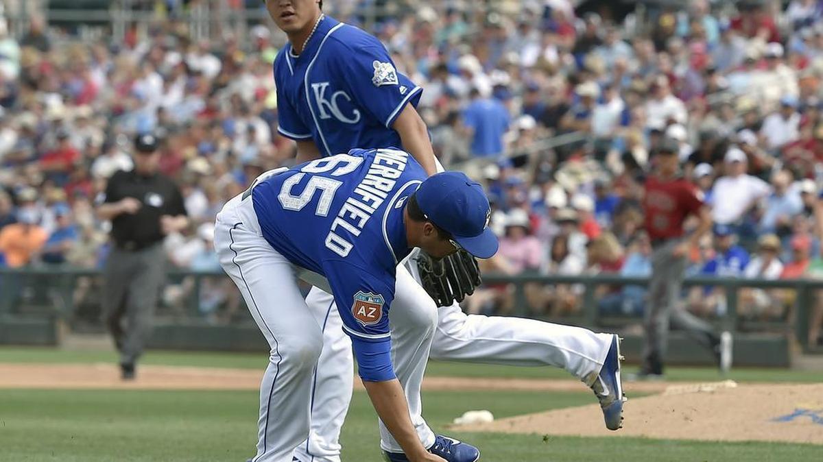 Kansas City Royals' Whit Merrifield fields a single hit by Arizona Diamondbacks' Carlos Rivero in front of pitcher Chien-Ming Wang in the seventh inning during Friday's spring training baseball game on March 11, 2016 in Surprise, Ariz.