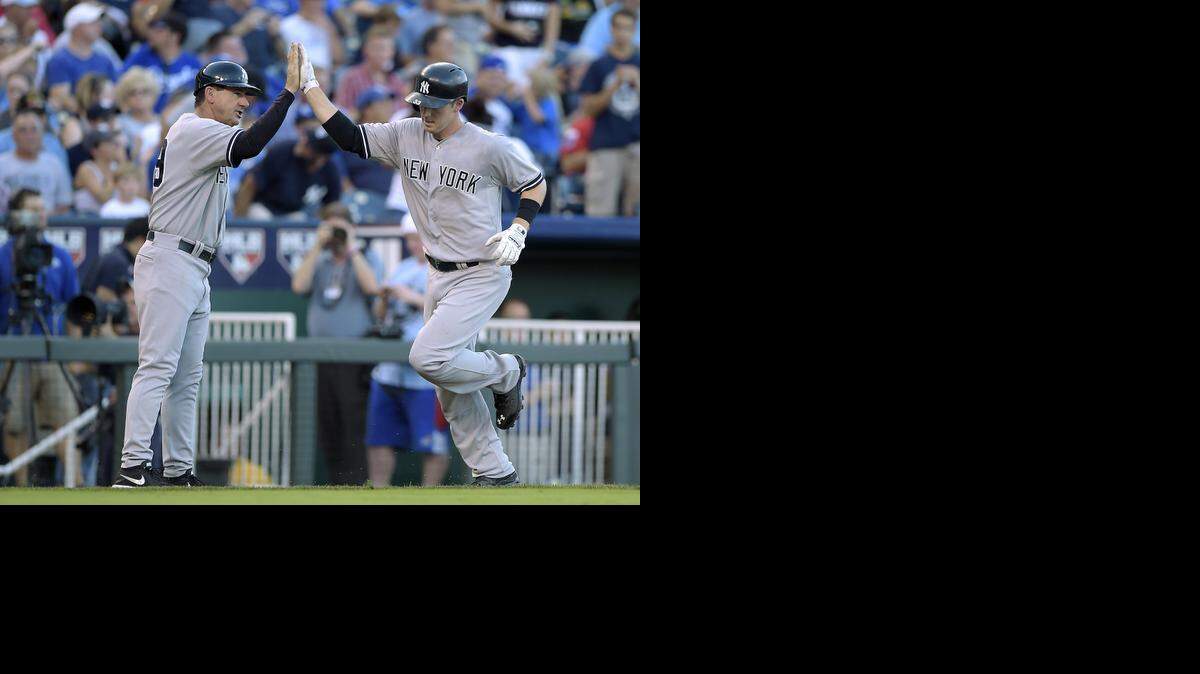 New York Yankees’ Stephen Drew (33) is congratulated by third base coach Rob Thomson after hitting a solo home run in the fourth inning during Monday’s baseball game against the Kansas City Royals on August 25, 2014, at Kauffman Stadium in Kansas City, Mo.