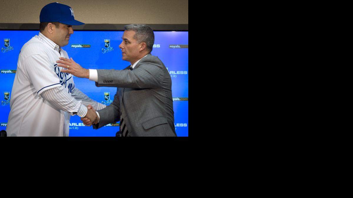 Royals general manager Dayton Moore (right) shook hands with the team's new first baseman/designated hitter Kendrys Morales on Tuesday, Dec. 16, 2014, at Kauffman Stadium.
