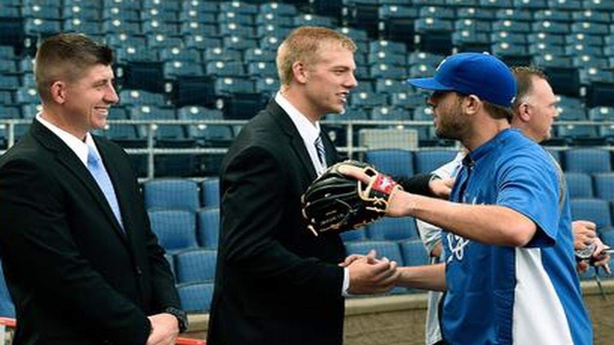 
Royals third baseman Mike Moustakas (8) stops to shake hands with Royals minor leaguer Hunter Dozier at batting practice before Friday's baseball game against the Tigers at Kauffman Stadium. The team honored their minor league player and pitchers of the year before the game.

