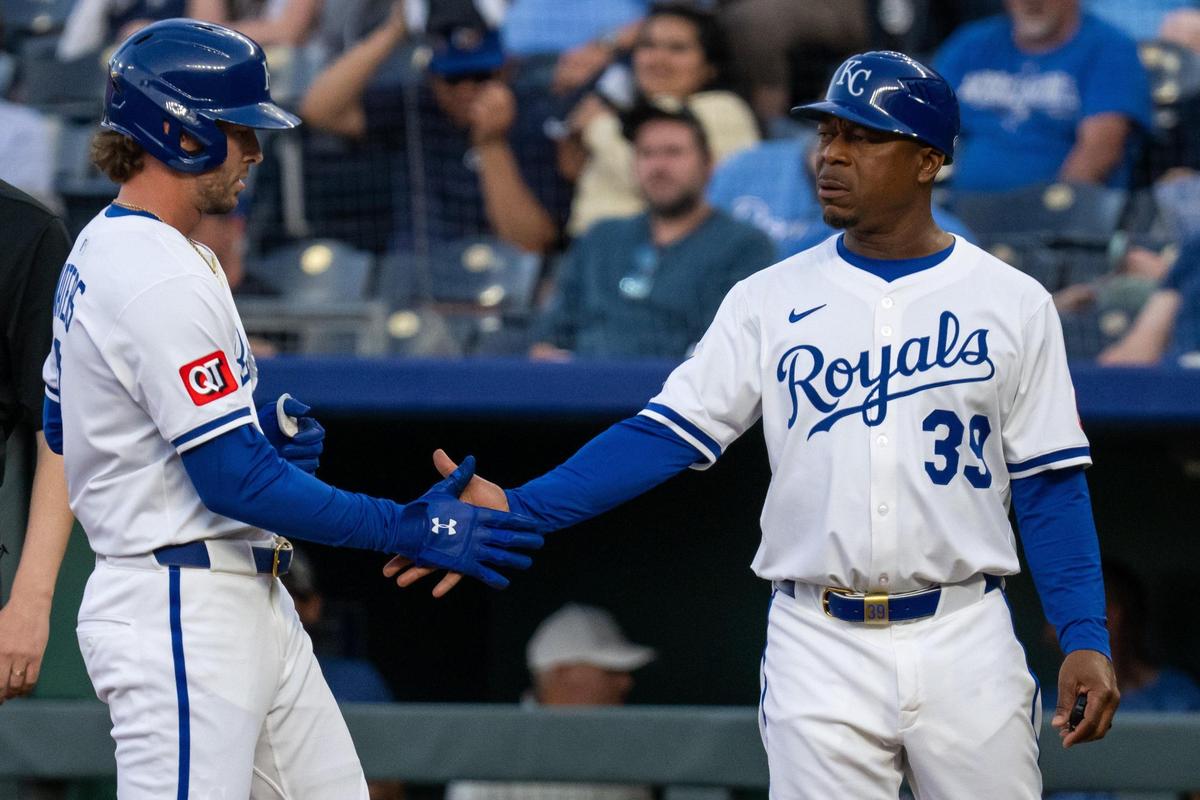 Kansas City Royals outfielder Drew Waters slaps five with first base coach Damon Hollins after hitting a single in the fourth inning of the game vs. the Colorado Rockies at Kauffman Stadium on Tuesday, April 22, 2025.