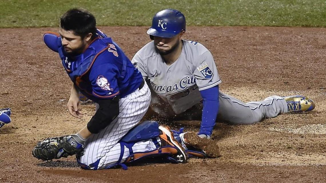 New York Mets catcher Travis d’Arnaud was pulled off home plate by a wide throw so he missed a chance to tag Kansas City Royals first baseman Eric Hosmer who scored in the ninth inning of Game 5 of the World Series at Citi Field in New York.