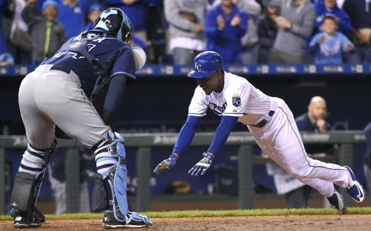 
The Jarrod Dyson scores on an inside-the-park home run ahead of the tag by Tampa Bay Rays catcher Rene Rivera (44) on an inside-the-park home run in the sixth inning Wednesday night at Kauffman Stadium. Alcides Escobar also scored on the play.
