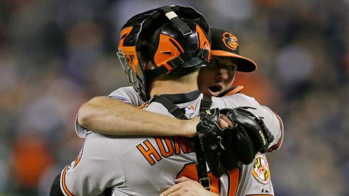 
Orioles relief pitcher Zach Britton (53) and catcher Nick Hundley celebrated after they defeated the Detroit Tigers 2-1 in Game 3 of their American League Division Series on Sunday in Detroit. Baltimore swept the series in three games and will face the Royals for the American League championship.
