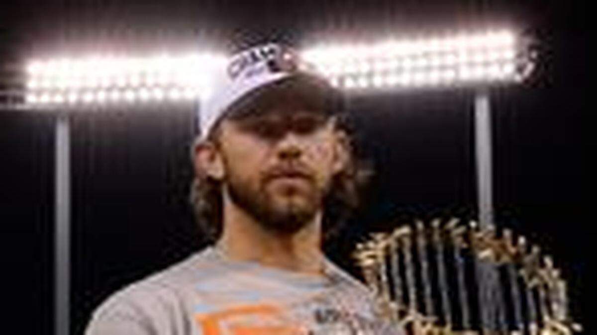 
Madison Bumgarner stood on the pitchers mound with the World Series trophy after the San Francisco Giants beat the Royals 3-2 in game seven of the World Series on Wednesday night at Kauffman Stadium. The Giants won the Series four games to three, and Bumgarner was chosen the MVP.

