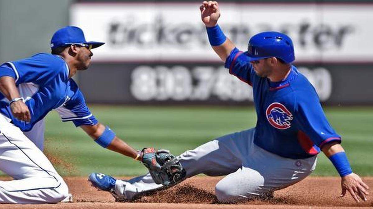 
Kansas City shortstop Alcides Escobar (2) took the throw from catcher Salvador Perez and tagged out Tommy La Stella out as La Stella tried to steal second base as the Royals and Chicago Cubs played Sunday in Cactus League action Sunday in Surprise, Ariz. The Cubs won 7-0.
