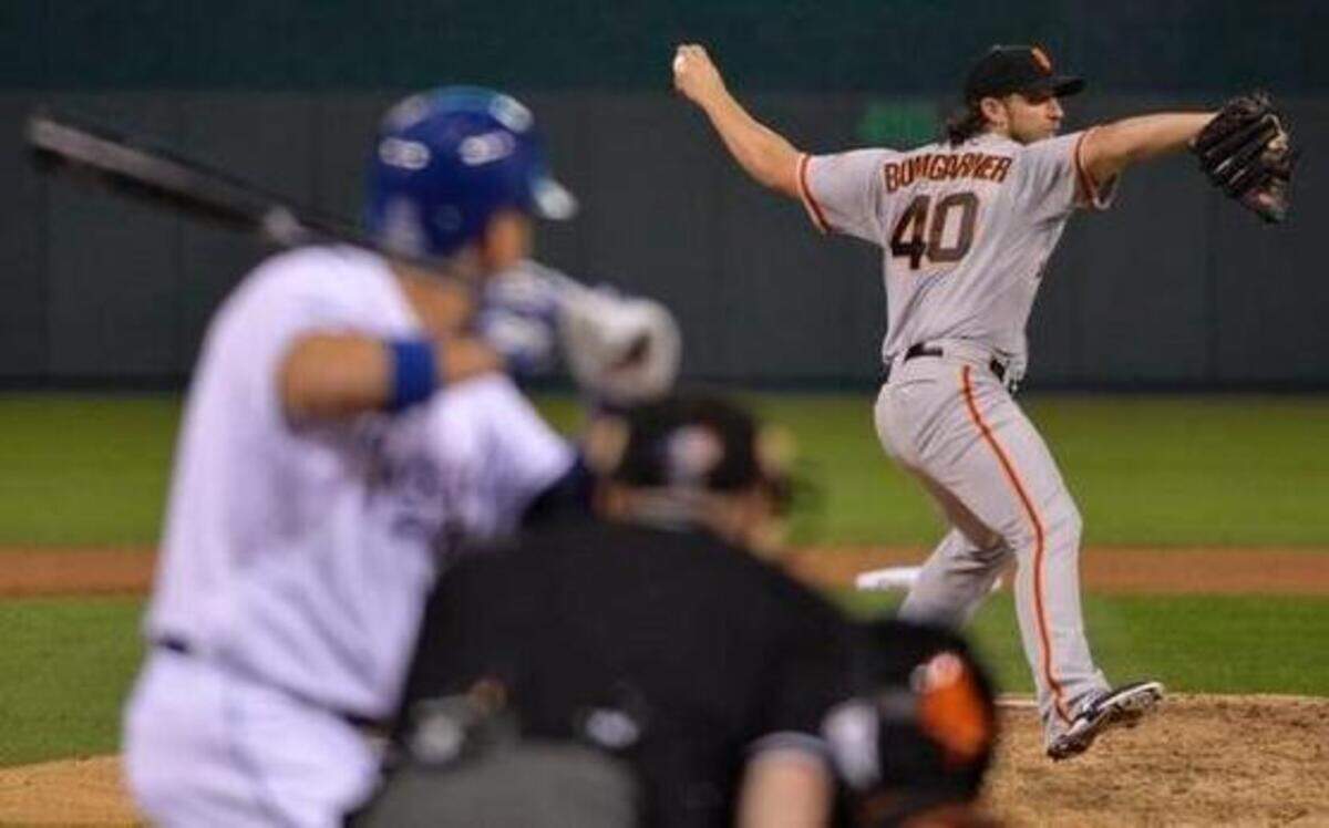 
San Francisco Giants starting pitcher Madison Bumgarner threw to Kansas City Royals second baseman Omar Infante in the fifth inning during game one of the World Series on Tuesday, October 21, 2014, at Kauffman Stadium in Kansas City, Mo. 
