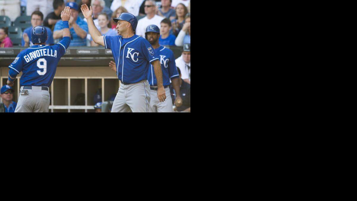 
Kansas City Royals second baseman Johnny Giavotella (9) gets a high-five from Kansas City Royals right fielder Raul Ibanez (18) after they score in the sixth inning during the Kansas City Royals and Chicago White Sox game at U. S. Cellular Field on Sunday, September 28, 2014, in Chicago, Illinois.
