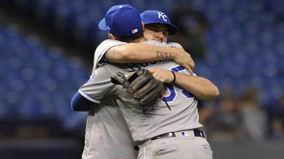 Royals third baseman Mike Moustakas (left) hugged first baseman Eric Hosmer after a 7-6 victory over the Rays on Tuesday in St. Petersburg, Fla. Moustakas’ homer in the 12th inning provided the winning margin.