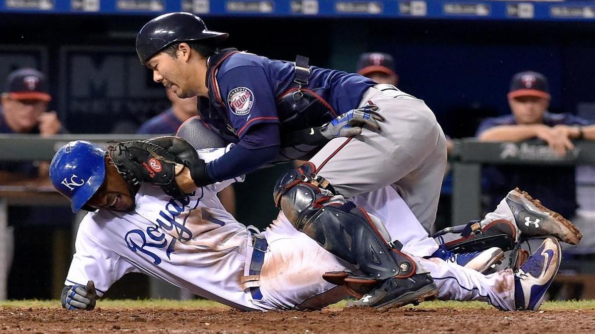 
Minnesota Twins catcher Kurt Suzuki (top) tagged out the Royals’ Jarrod Dyson in the 10th inning as Dyson tried to score on a single by Mike Moustakas on Wednesday night at Kauffman Stadium. The Twins won the game 3-2 on Miguel Sano’s pinch-hit home run in the 12th.
