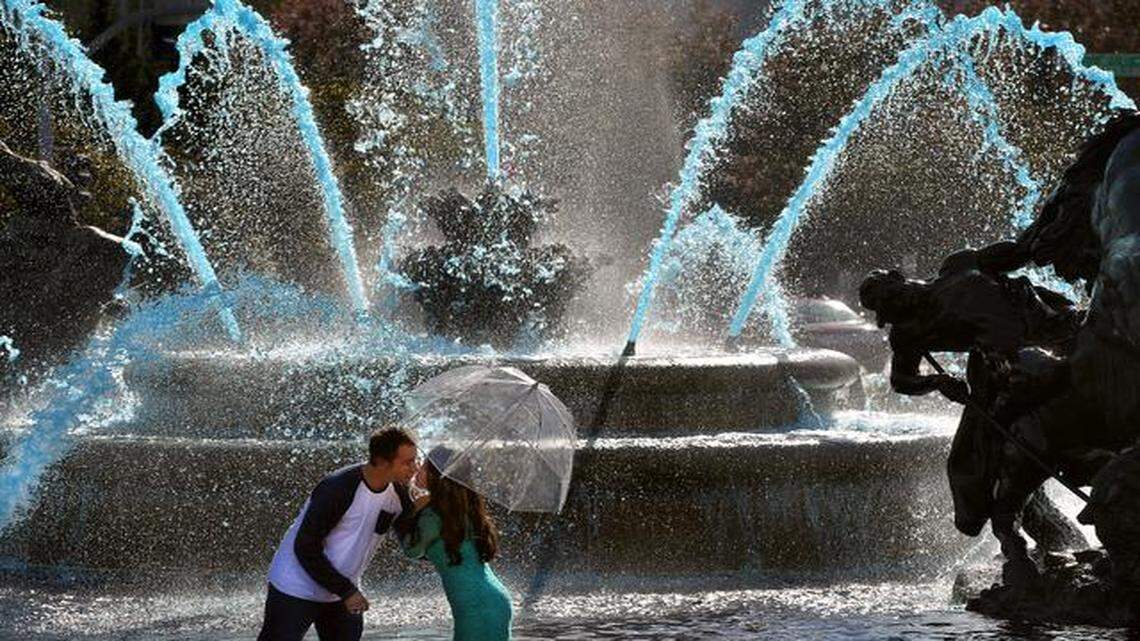 
The blue water of the J.C. Nichols Fountain proved to be a perfect engagement photo backdrop Thursday for Brett Budke, 33, and his fiancee, Jessica Geiss, 27, both of Olathe. And the timing couldn’t have been better, with the Royals having clinched a berth in the World Series the day before and Brett Budke being named after Hall of Famer George Brett. The couple are Kansas City natives and both longtime Royals fans. “It was a fun day today to do our pictures right after the game,” Budke said. “What a fun time for the city. It is fun to be able to support the Royals and feel good about it.”
