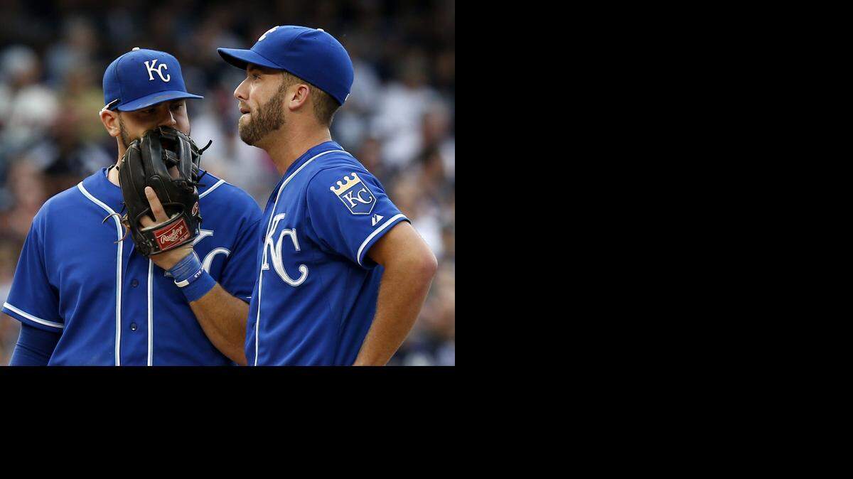 The Royals’ Mike Moustakas (left) talked talks with starting pitcher Danny Duffyin the first inning against the New York Yankees on Saturday in the Bronx. Duffy left the game with a sore shoulder after throwing one pitch.