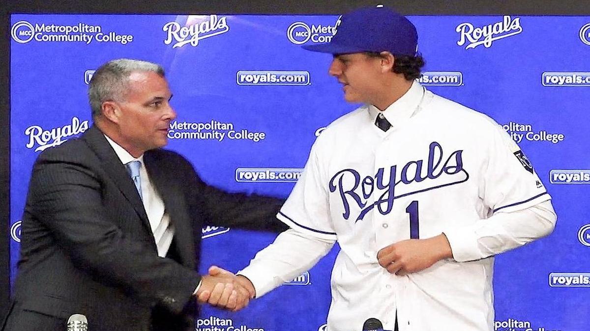 Kansas City Royals general manager Dayton Moore shakes hands with first-round draft pick Nick Pratto.